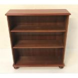 MAHOGANY OPEN BOOKCASE with a moulded top above two adjustable shelves, standing on flattened bun