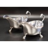 PAIR OF EDWARD VIII SILVER SAUCE BOATS with serpent scroll handles, raised on three serpent