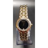 LADIES RAYMOND WEIL EIGHTEEN CARAT GOLD PLATED WRISTWATCH the black dial with date aperture at 6 and