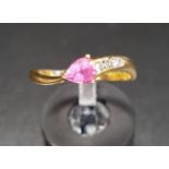 PINK SAPPHIRE AND DIAMOND RING the pear cut pink sapphire with three diamonds to one side of the