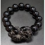 ONXY BEAD BRACELET comprising thirteen beads and a carved dog of foe style section