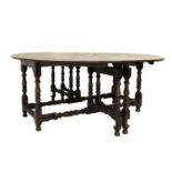 VERY LARGE OAK GATELEG TABLE with shaped drop flaps, standing on turned supports united by