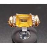 CITRINE AND DIAMOND DRESS RING the central emerald cut citrine flanked by diamond set shoulders,