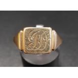 EIGHTEEN CARAT GOLD SIGNET RING with engraved scroll monogram, ring size R and approximately 3.3
