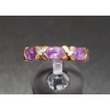 AMETHYST AND DIAMOND RING the three oval cut amethysts separated by diamonds in X settings, on ten