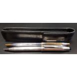 SILVER CROSS BALL POINT PEN with silver barrel and cap, in leather pouch; together with another