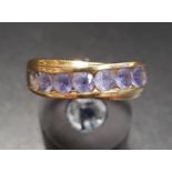 CHANNEL SET IOLITE DRESS RING in fourteen carat gold, ring size P