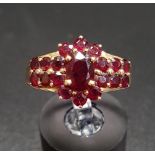 GARNET CLUSTER RING the central cluster flanked by further garnets to the shoulders, on fourteen