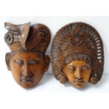 PAIR OF BALINESE CARVED MASKS depicting a male and female with traditional headwear (2)