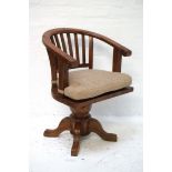 TEAK CAPTAIN'S STYLE SWIVEL CHAIR with a hoop back above a solid seat with a shaped cushion,