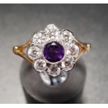 AMETHYST AND DIAMOND CLUSTER RING the central amethyst in eight diamond surround, the diamonds