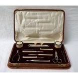 CASED IVORINE MANICURE SET the various implements and tools with niello style decoration to the