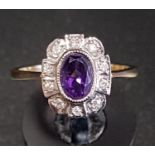 AMETHYST AND DIAMOND CLUSTER RING the central oval cut amethyst in ten diamond surround, on nine