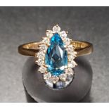 BLUE TOPAZ AND DIAMOND DRESS RING the central blue topaz approximately 1ct in sixteen diamond