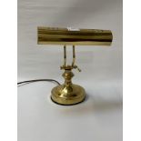 BRASS DESK LAMP raised on a circular base with adjustable arm and light shade