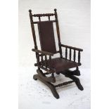 CHILD'S MAHOGANY ROCKING CHAIR of turned column form with a part padded leatherette back above a