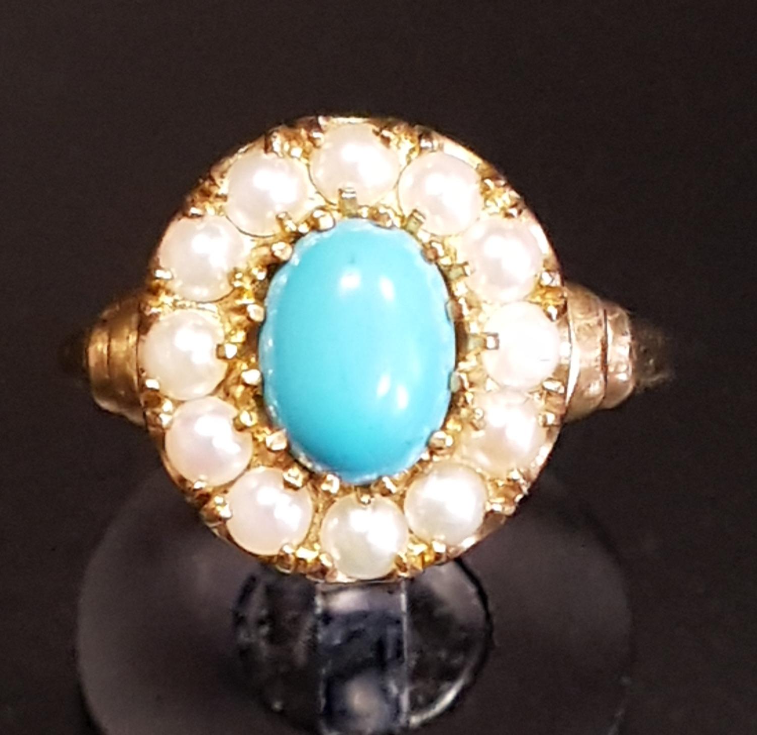 TURQUOISE AND SEED PEARL CLUSTER RING the central oval cabochon turquoise stone in twelve pearl