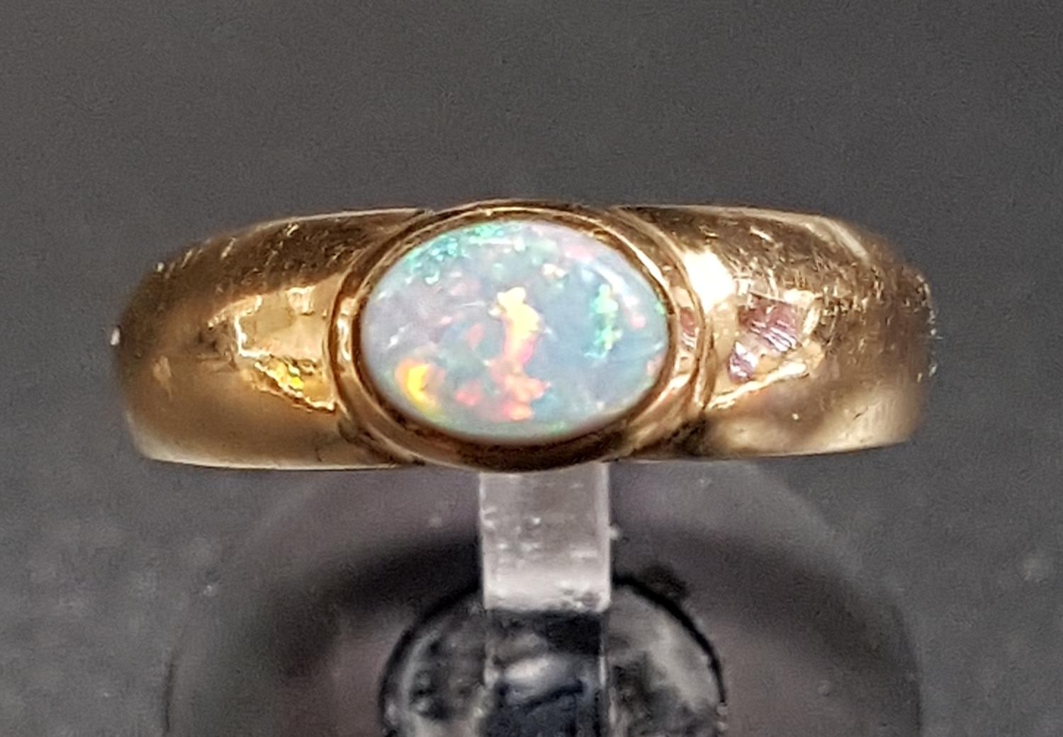 OPAL SINGLE STONE DRESS RING the bezel set opal on nine carat gold shank, ring size L-M