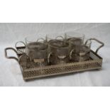 SET OF SIX SILVER PLATED GLASS HOLDERS AND TRAY each of the glass holders with pierced decoration