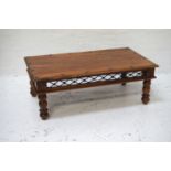 TEAK OBLONG OCCASIONAL TABLE with decorative ironwork, standing on turned supports, 110cm wide