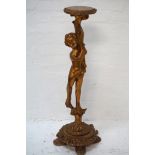 GILTWOOD TORCHERE with a circular top supported by a putti, raised on a decorative circular base