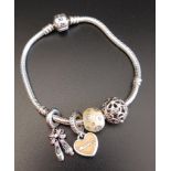 PANDORA MOMENTS SILVER CHARM BRACELET with four charms including a floral pierced ball and ballet