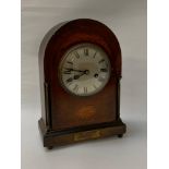 EDWARDIAN MAHOGANY MANTLE CLOCK with an arched inlaid case, circular silvered dial with Roman
