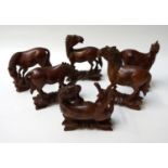 SET OF SIX CARVED WOOD HORSES all in different poses and on carved stands, tallest 12cm high (6)