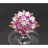 RUBY AND DIAMOND CLUSTER RING in stepped setting and on nine carat gold shank, ring size L-M