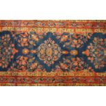 BLUE GROUND RUG with profuse floral decoration encased in a multi layered border, 146cm x 67cm