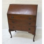 MAHOGANY BUREAU with a fall inset flap and fitted interior above three graduated drawers, standing