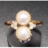 UNUSUAL PEARL AND DIAMOND RING the two vertically set pearls flanked by three small diamonds to each
