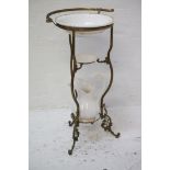 BRASS WASHSTAND raised on three shaped supports, the shaped bowl recess with an outer shaped