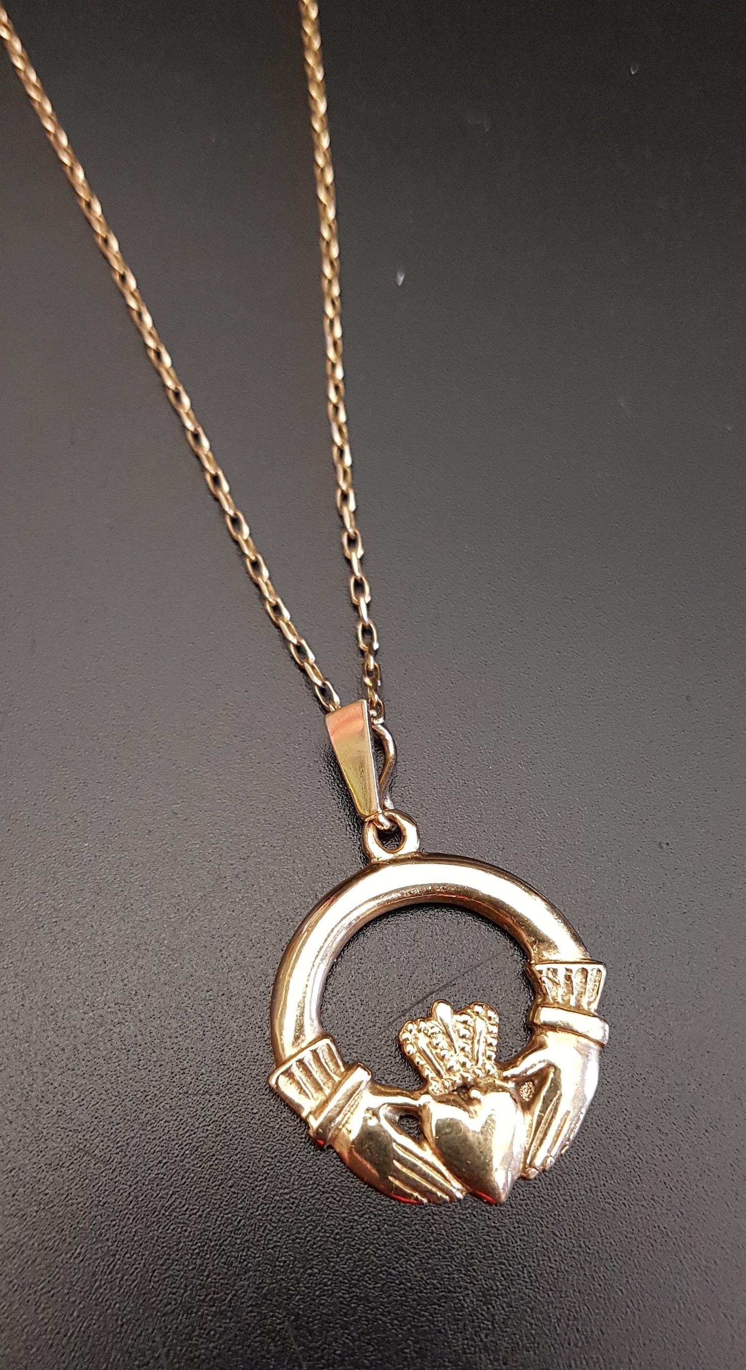 NINE CARAT GOLD CLADDAGH PENDANT on nine carat gold chain, total weight approximately 7.3 grams