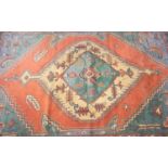 KELIM TYPE RUG with a central lozenge motif in green and cream surrounded by a coral section and
