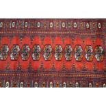 ISHFAN RUG with a red ground and multi lozenge sectional decoration within a geometric border,