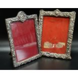 AN EDWARDIAN AND A VICTORIAN SILVER PHOTOGRAPH FRAME both with profuse embossed scroll decoration,