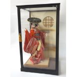 JAPANESE FIGURE OF A GEISHA GIRL IN GLASS CASE the geisha girl in tradition costume, the case