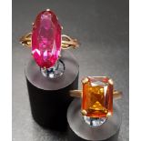 TWO NINE CARAT GOLD DRESS RINGS one with radiant cut orange gemstone and the other with oval red