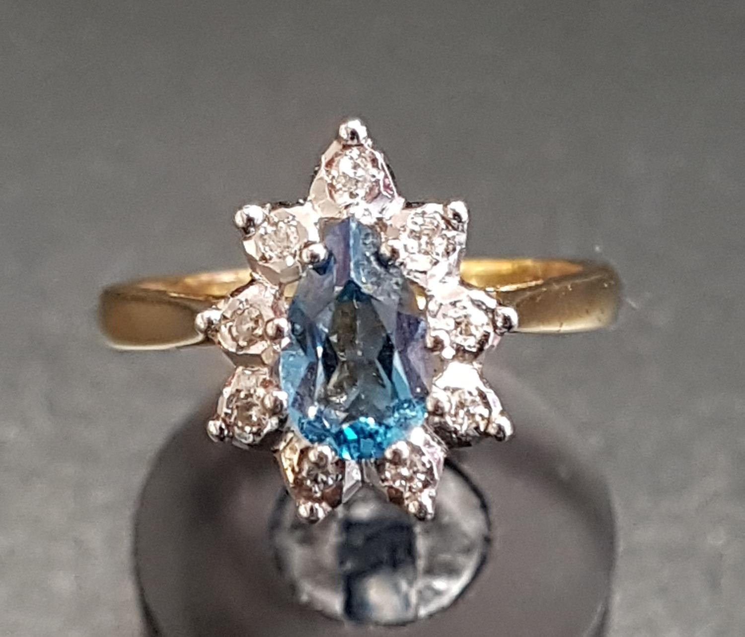 BLUE TOPAZ AND DIAMOND CLUSTER RING the pear cut blue topaz approximately 0.75cts in nine diamond