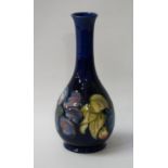 MOORCORFT VASE the bottle with Clematis pattern on a dark blue ground, with painted and impressed