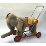 CHILDS MERRYTHOUGHT RIDE ON ELEPHANT with a grey fur body, headpiece and saddle cloth, mounted on