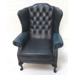 CHESTERFIELD WING BACK ARMCHAIR in blue leather with decorative stud detail, standing on cabriole