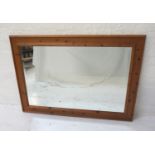 OBLONG WAXED PINE WALL MIRROR with a bevelled plate, 101cm wide