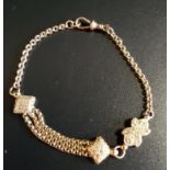 UNUSUAL NINE CARAT GOLD ALBERTINA BRACELET with central shaped links and triple chain section,