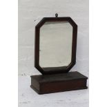 MAHOGANY WALL MOUNTED DRESSING MIRROR with an oblong frame with canted corners above a serpentine