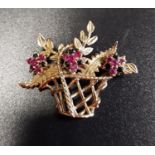 RUBY AND SAPPHIRE NINE CARAT GOLD BROOCH in the form of a basket of flowers, with three ruby and