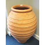 LARGE TERRACOTTA POT of bulbous form with ribbed decoration, 81cm high