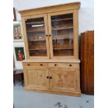 VICTORIAN PINE HOUSEKEEPERS CUPBOARD with a moulded cornice above a pair of glass cupboard doors,