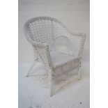 CANED CONSERVATORY TYPE ARMCHAIR with a shaped pierced back, standing on turned supports and painted
